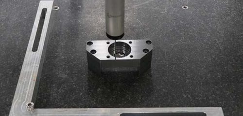 Custom CNC machining is the production of parts to your specification — your design, your material, your tolerance, your quantity — on computer-controlled machines. “CNC” stands for computer numerical control: the machine follows a program built from your CAD model and cuts the part out of solid stock. No molds, no dies, no minimum order in the thousands. That last part matters more than buyers realize. Because there’s no hard tooling, CNC machining is economical from a single prototype up through mid-volume production. It’s the only path for one-off aerospace test parts, the practical path for medical device prototypes, and the fastest path for a redesign that has to ship next week.